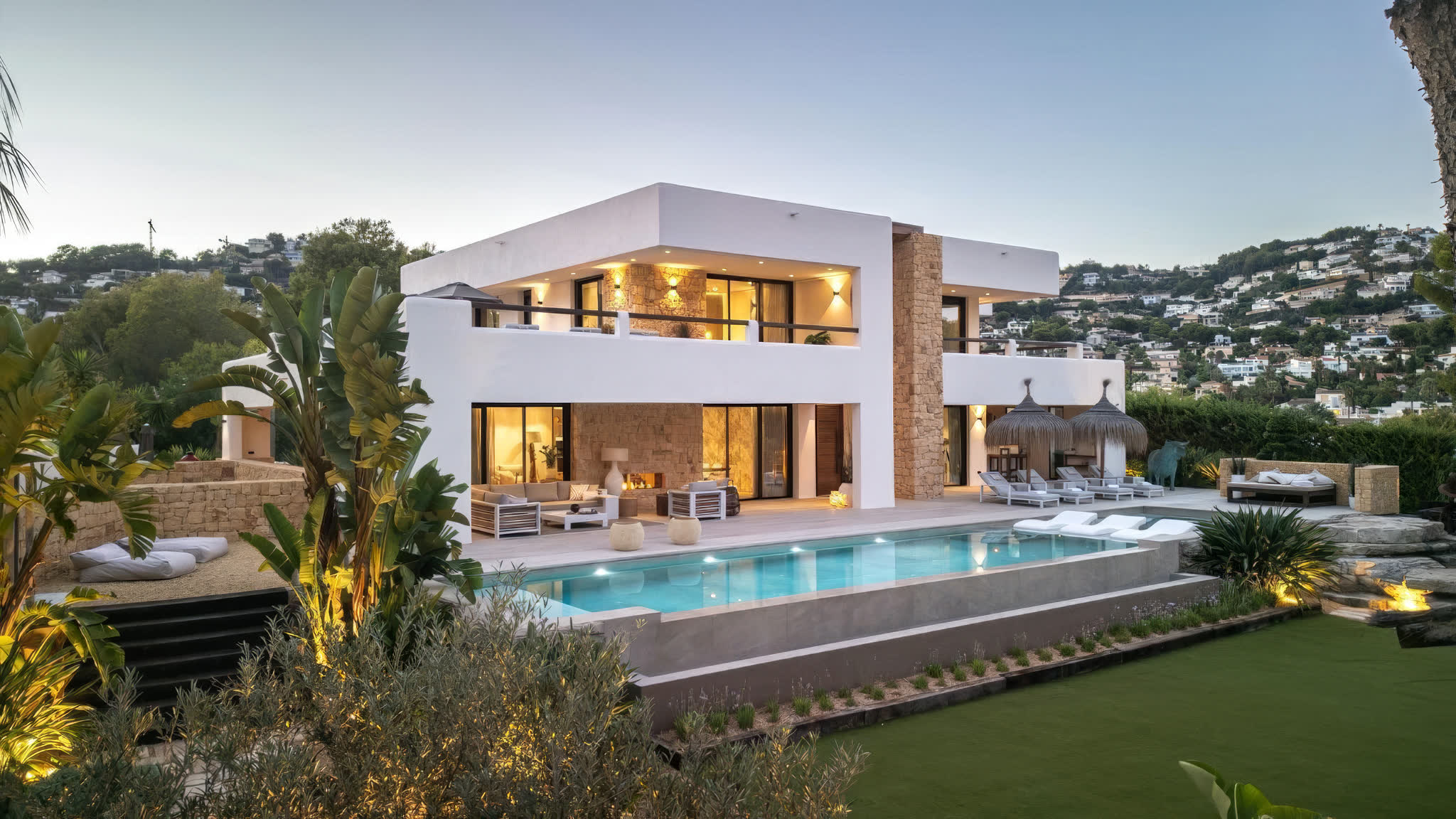Modern villa with illuminated pool and contemporary architecture overlooking the Costa Blanca coast