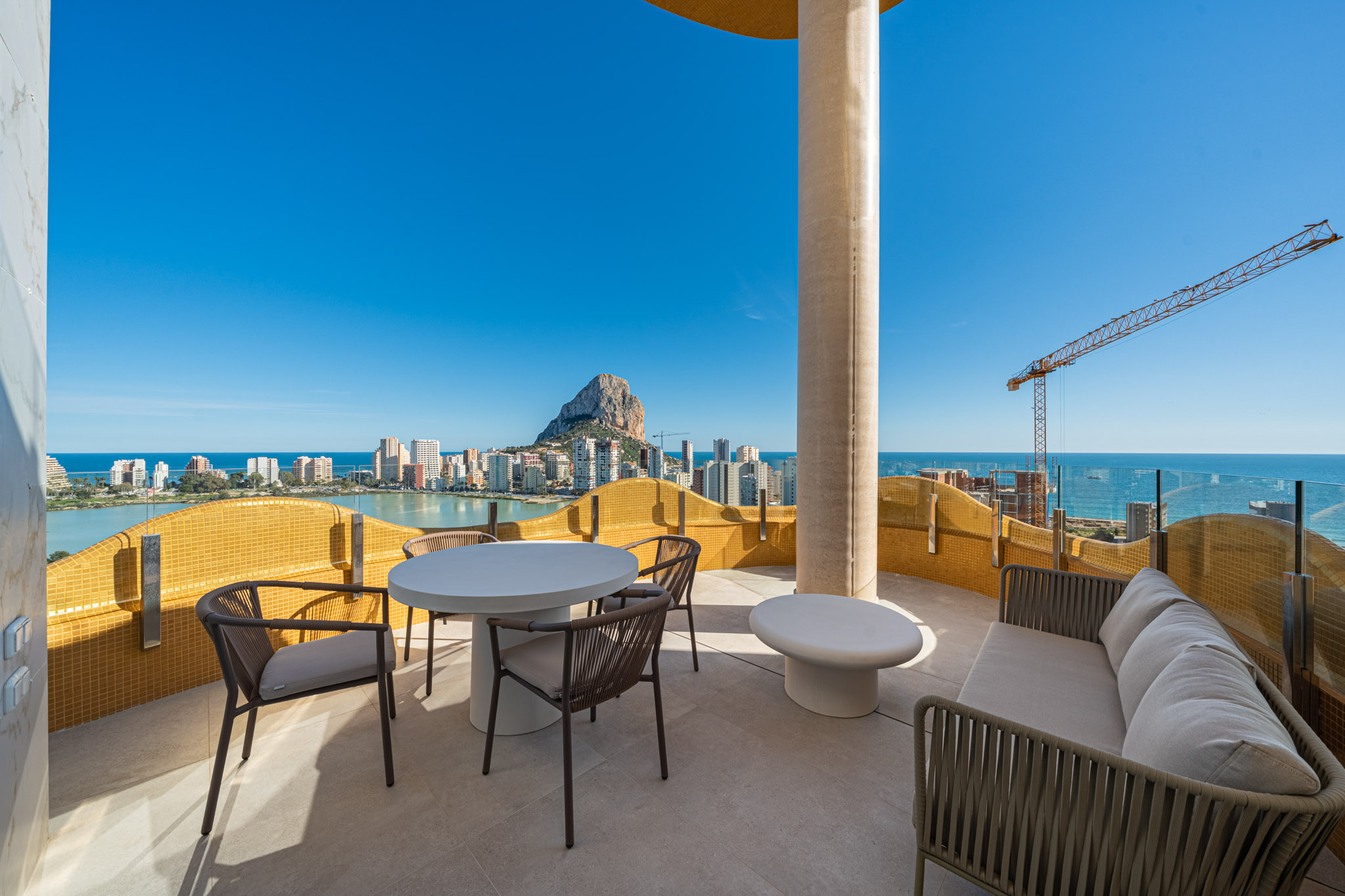 The table and the outdoor sofa on the terrace, with the sea beyond