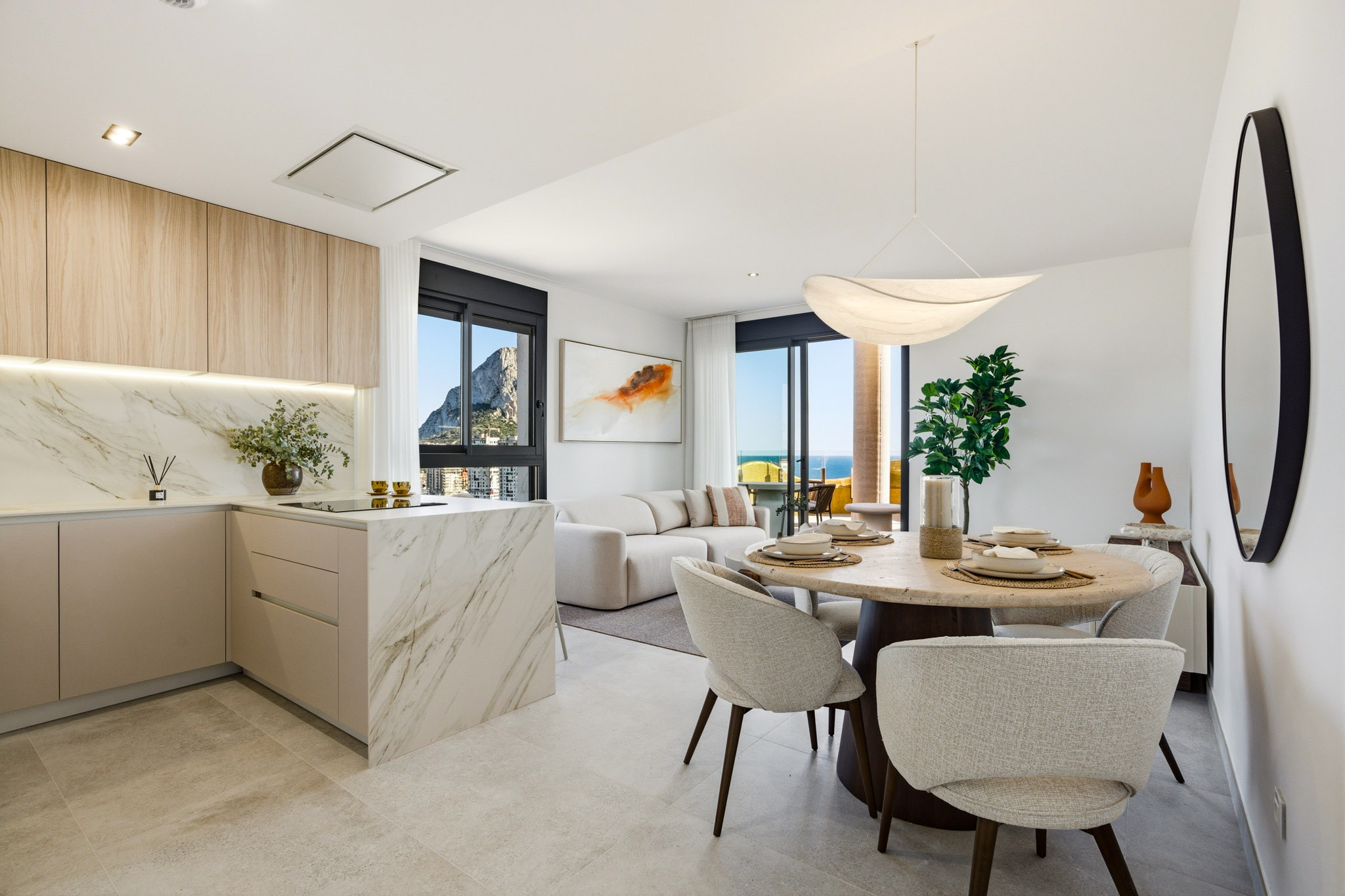 The kitchen, the dining table and the living room, with the Peñón in the window