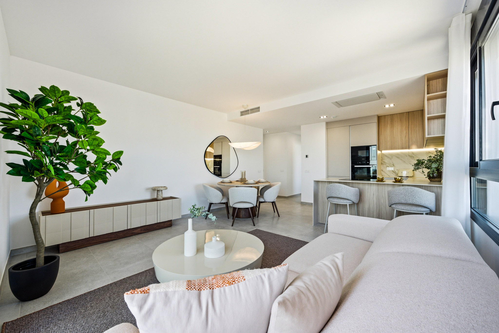 The living room, looking back to the dining table and the kitchen